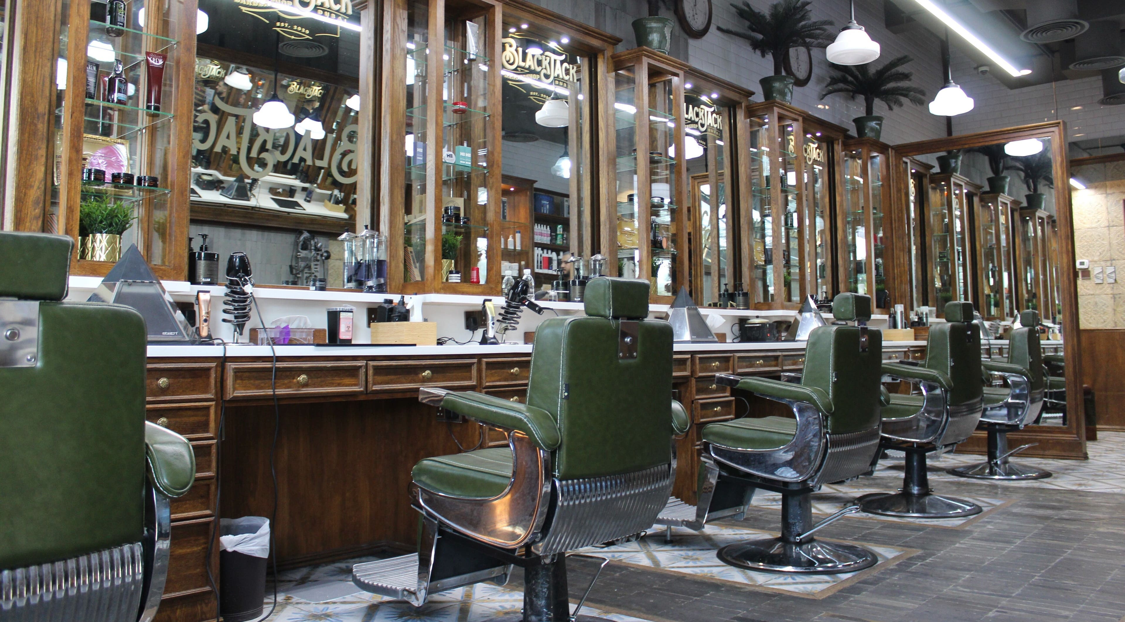 Interior of JUMEIRAH 3 BLACK JACK BARBER SHOP, Dubai, Dubai, AE showcasing elegant barber chairs and mirrors.