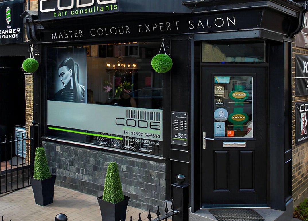 Front view of CODE Hair Consultants salon in Lowestoft, England, showcasing elegant design and signage.