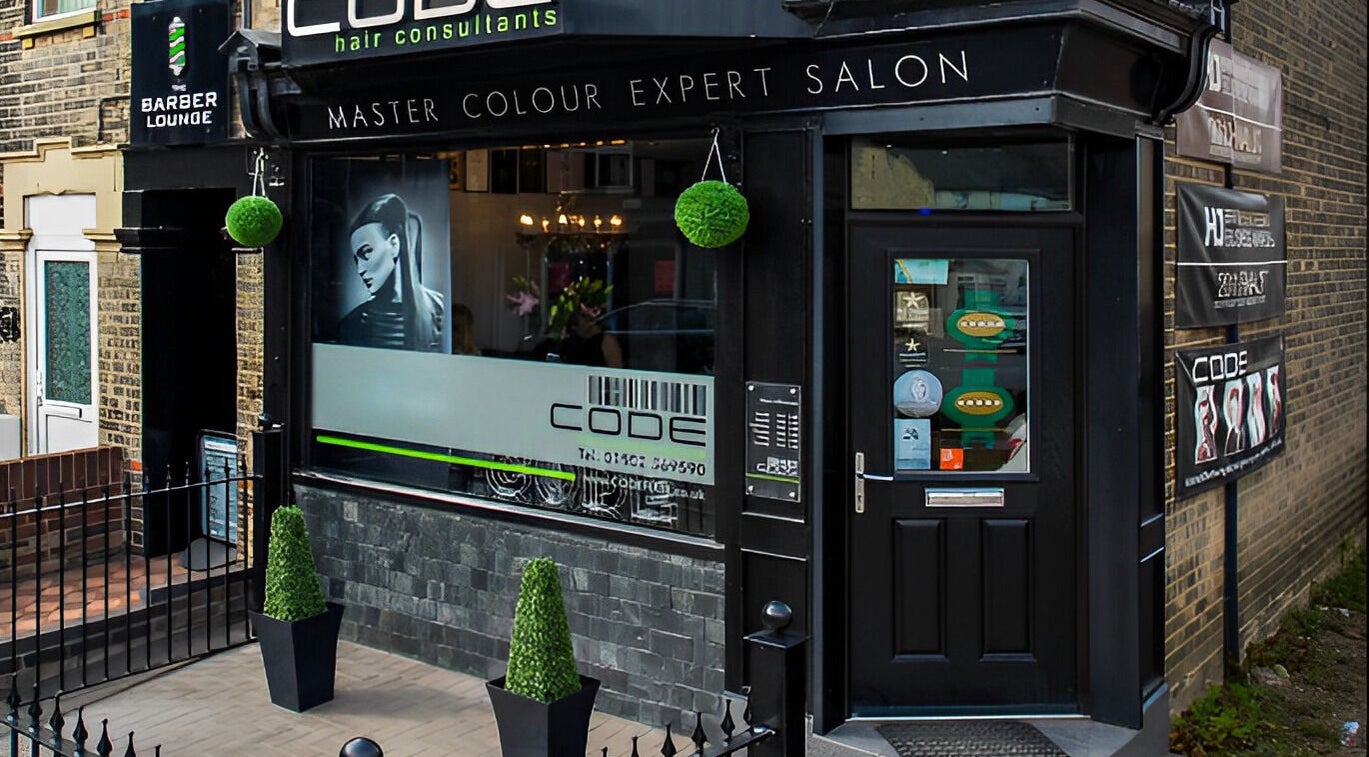 Front view of CODE Hair Consultants salon in Lowestoft, England, showcasing elegant design and signage.