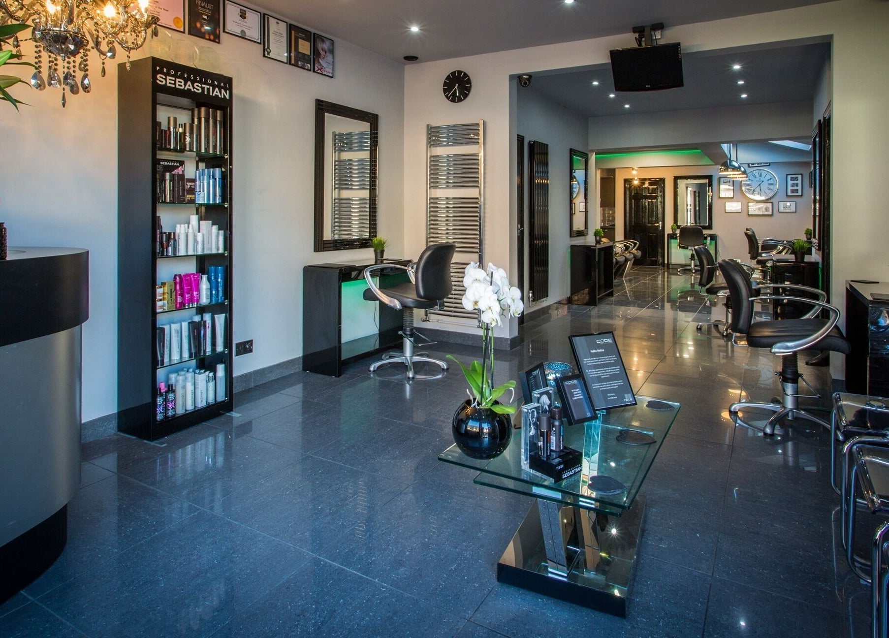 Elegant interior of CODE Hair Consultants in Lowestoft, England, showcasing modern salon chairs and stylish decor.