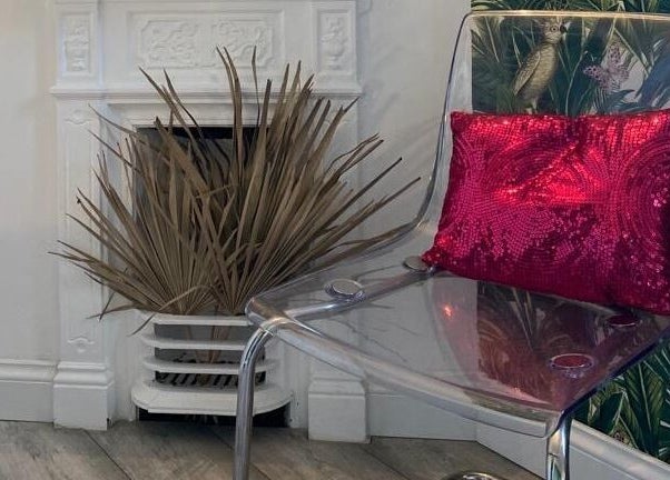 Stylish seating at CODE Hair Consultants with clear chair and red cushion. Lowestoft, England, GB.