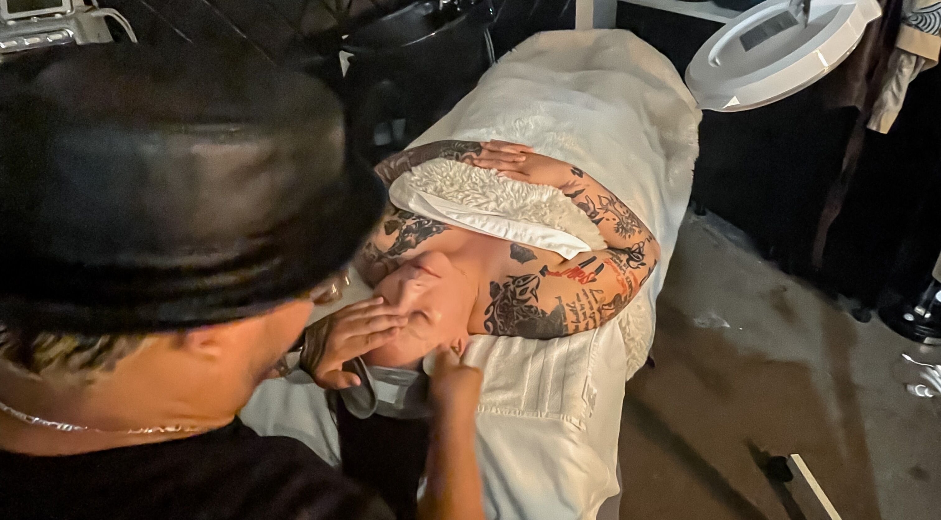 Client enjoying facial massage at Skin and Scissors Beauty Studio in Orange, California, US.