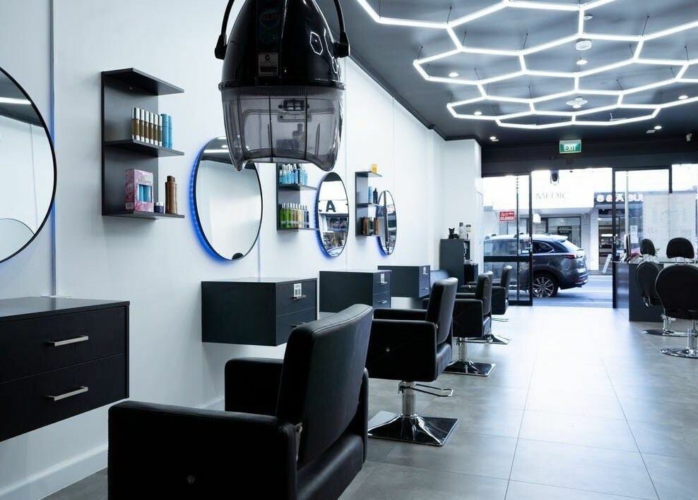 Modern interior of 3 Points Hair Extensions and Barbering in Melbourne, Victoria, AU, featuring sleek black chairs.