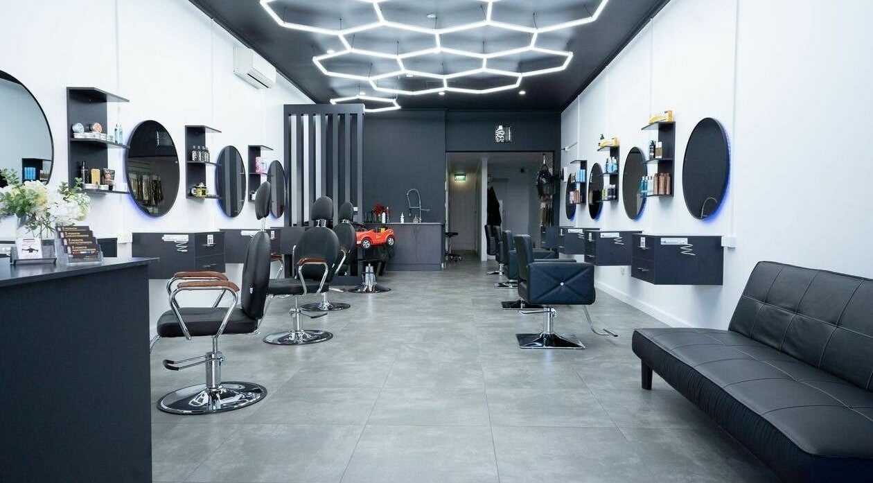 Inside 3 Points Hair Extensions and Barbering, Melbourne, Victoria, AU: sleek chairs, mirrors, and ambient lighting.