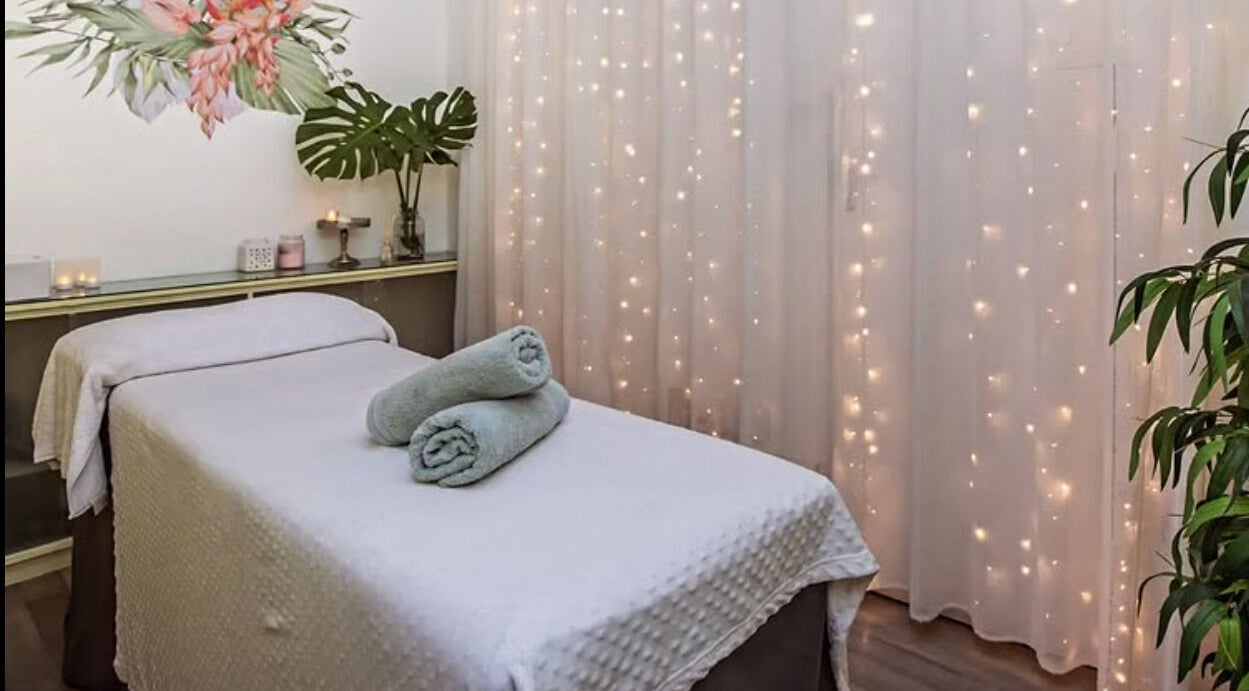 Relaxing massage room at Flourish Salon, Durban North, KwaZulu-Natal, ZA, featuring soft lighting and decor.