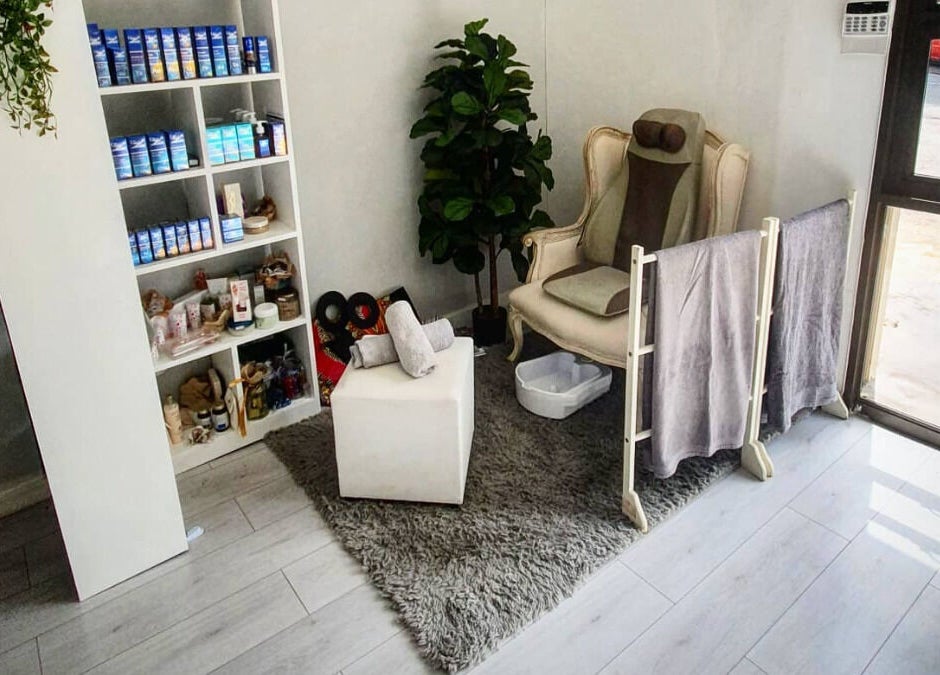 Relaxing treatment area at Flourish Salon, Durban North, KwaZulu-Natal, ZA. Comfortable chair, towels, and products.