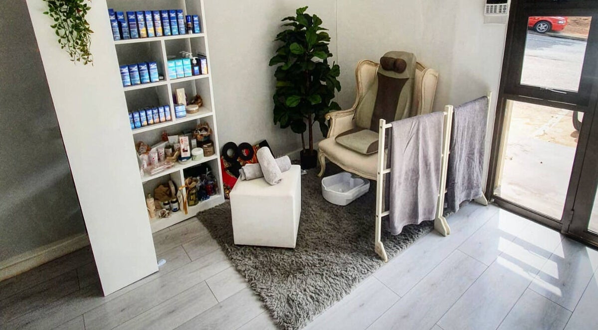 Relaxing treatment area at Flourish Salon, Durban North, KwaZulu-Natal, ZA. Comfortable chair, towels, and products.