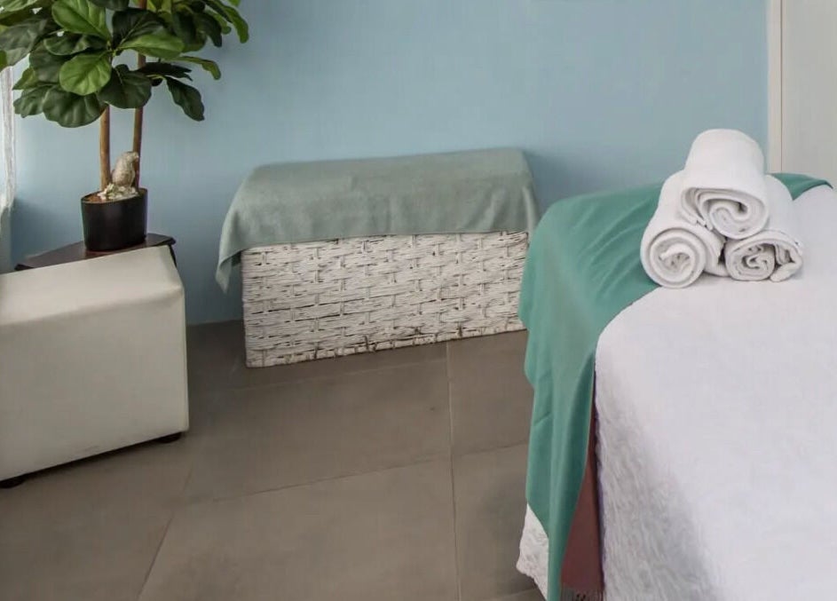 Peaceful treatment room at Flourish Salon in Durban North, KwaZulu-Natal, ZA featuring a massage table.