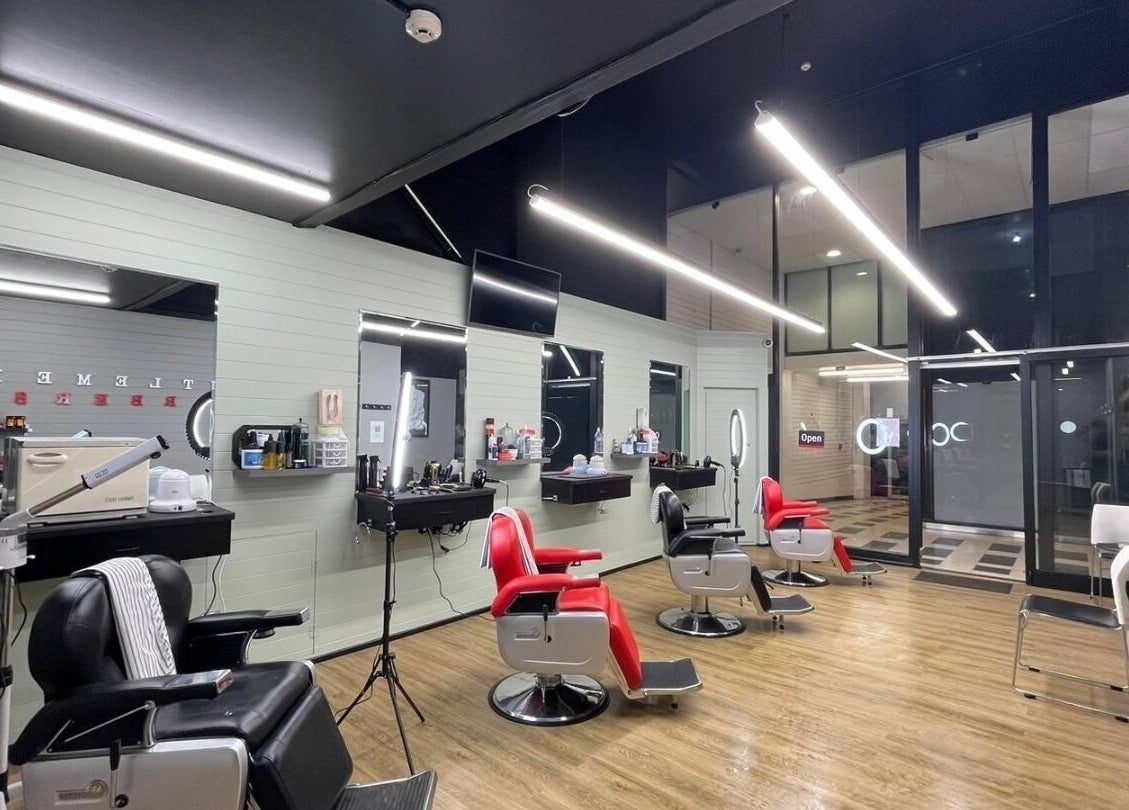 Modern interior of Gentlemen's Barbers Hamilton in Waikato, NZ with stylish red and black barber chairs.