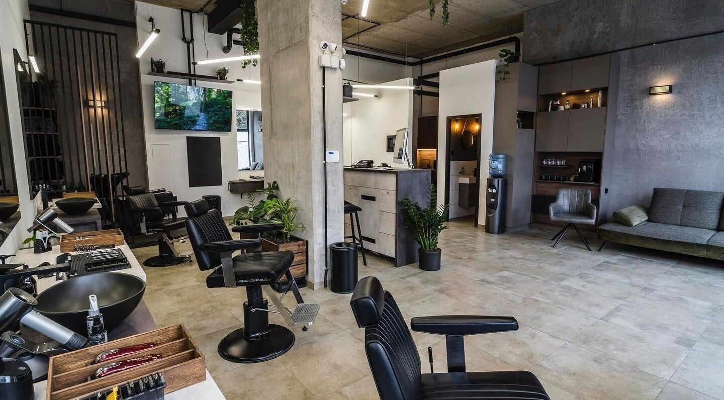 Modern salon interior at Initials, featuring sleek black chairs and greenery, Budapest, Magyar, HU.