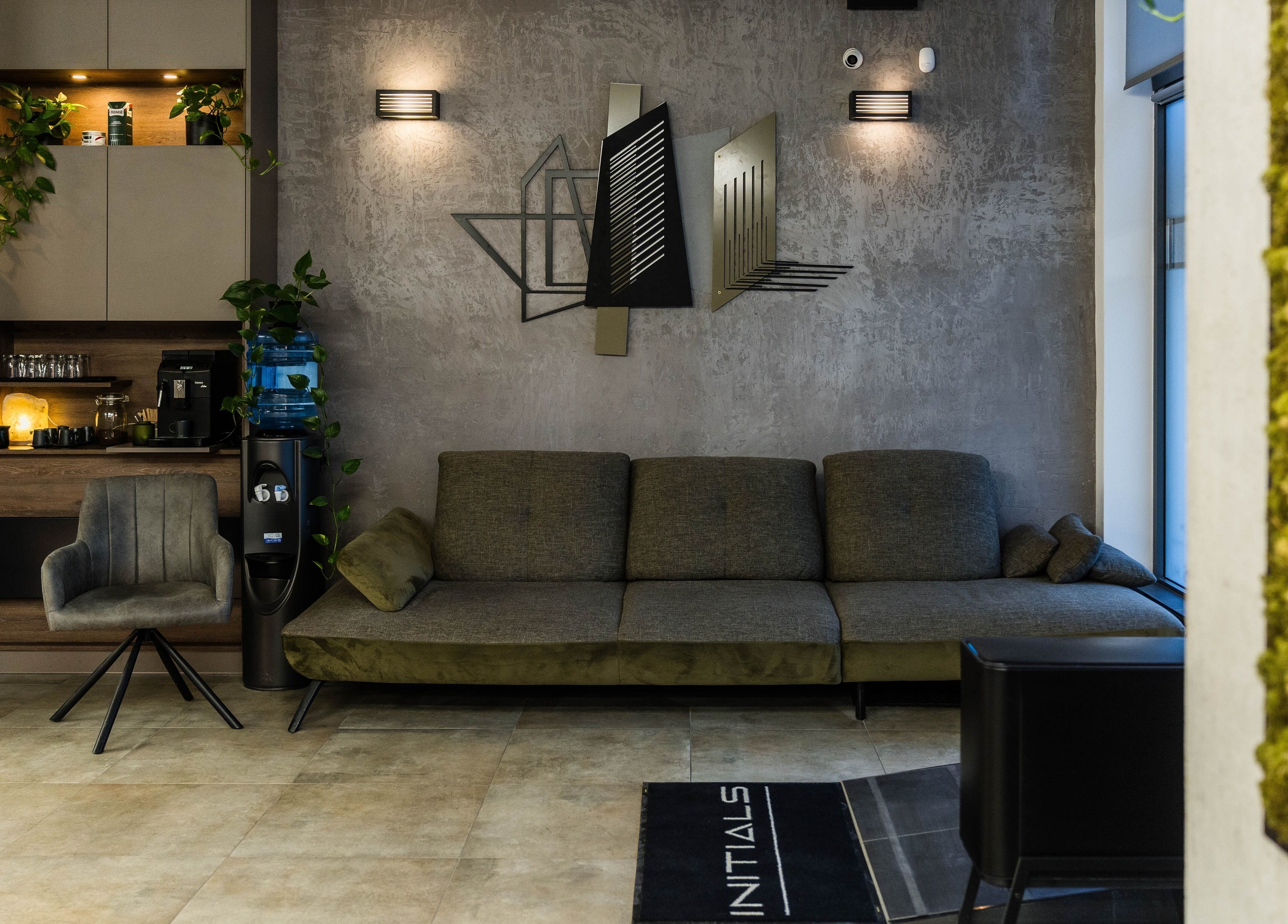 Stylish lounge area at Initials, Budapest, Magyar, HU featuring a contemporary sofa and modern decor.