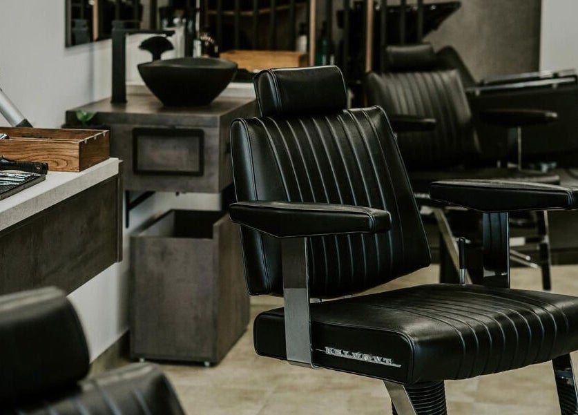 Luxurious salon chair at Initials, Budapest, Magyar, HU offering premium hairdressing services.