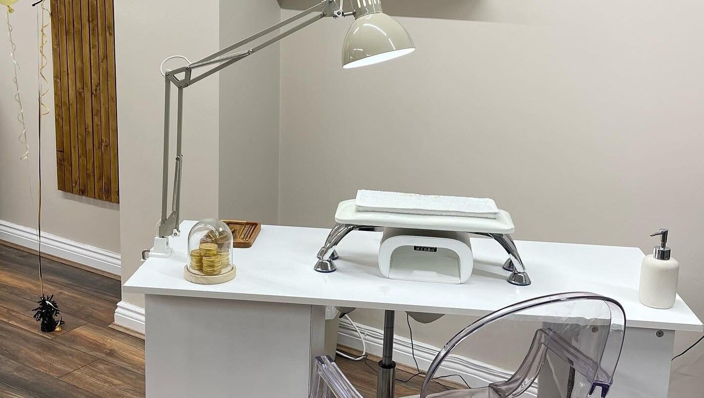 Elegant nail station at Repose Beauty and Wellbeing, Macclesfield, England, GB, featuring a lamp and modern chair.