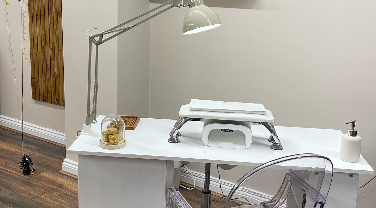 Elegant nail station at Repose Beauty and Wellbeing, Macclesfield, England, GB, featuring a lamp and modern chair.