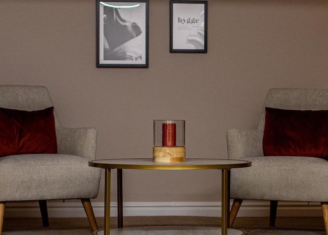 Comfortable sitting area with plush chairs at Repose Beauty and Wellbeing, Macclesfield, England, GB.