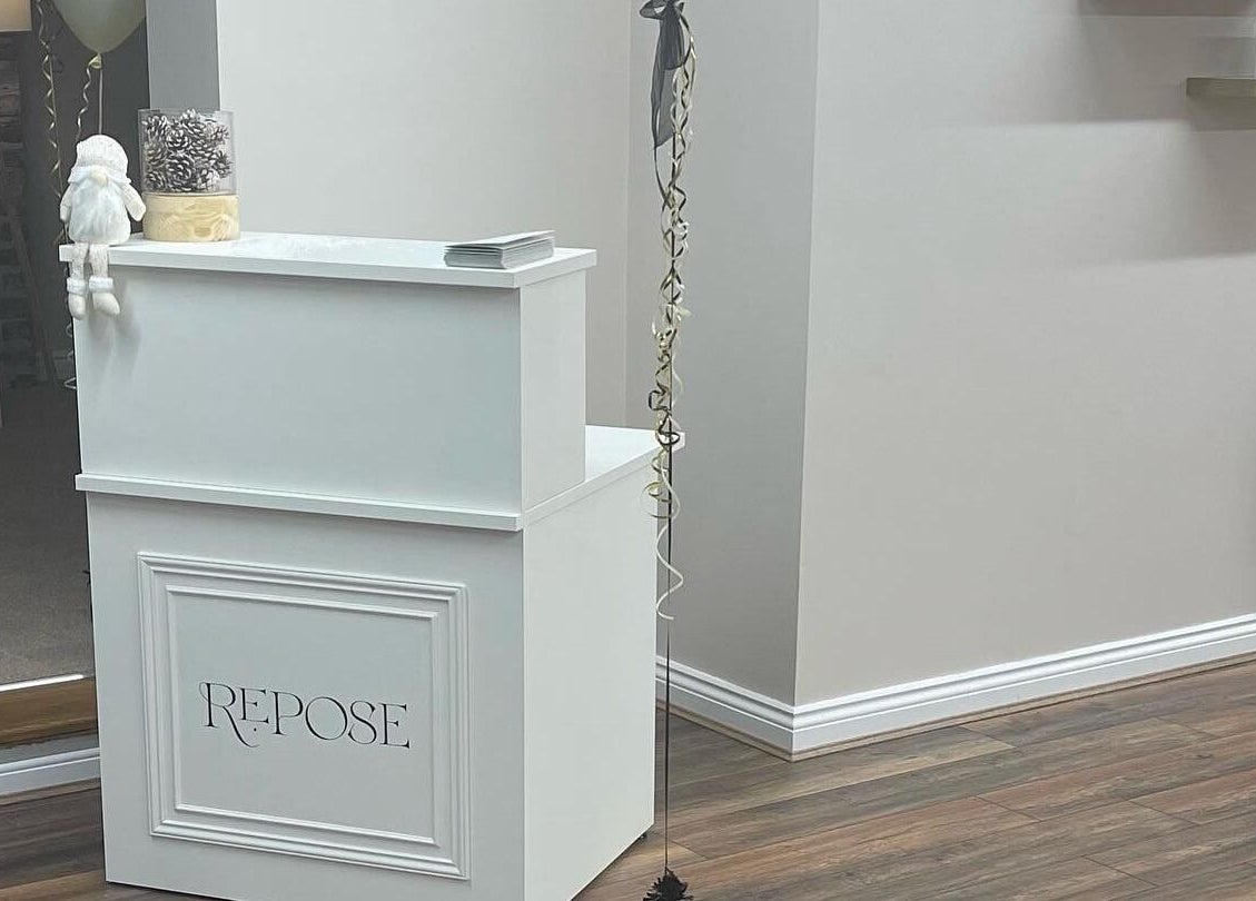 Reception area at Repose Beauty and Wellbeing, Macclesfield, England, GB with elegant decor and products.