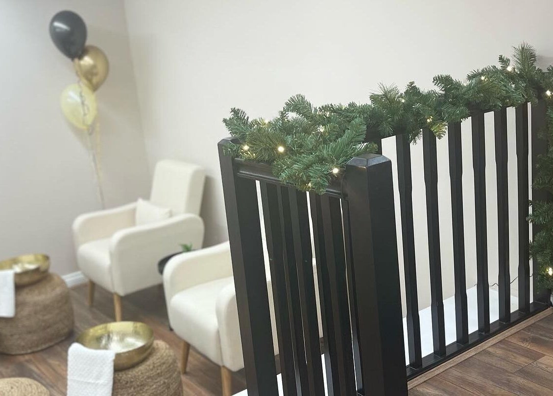 Elegant seating area at Repose Beauty and Wellbeing, Macclesfield, England, GB, adorned with festive greenery.