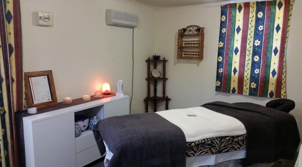 Relaxing spa room at Totally You Beauty in Hamilton, Waikato, NZ, featuring a massage bed and tranquil decor.