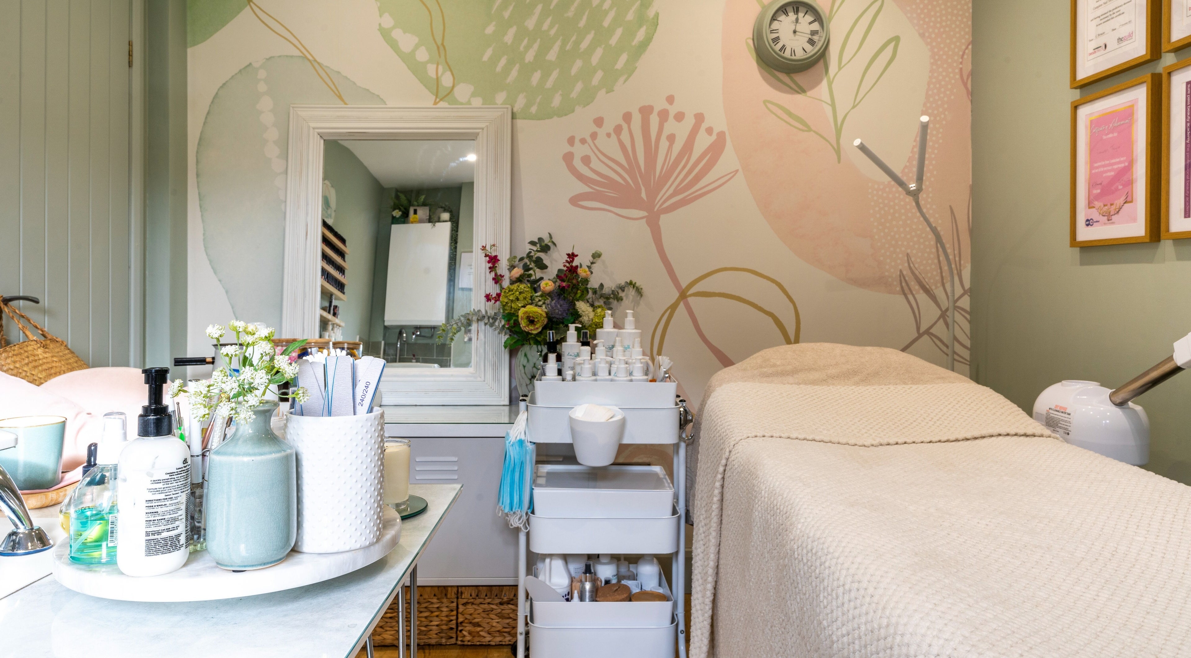 Bright, serene beauty treatment room at Taylored Beauty, Swanton Morley, England, GB with floral decor.