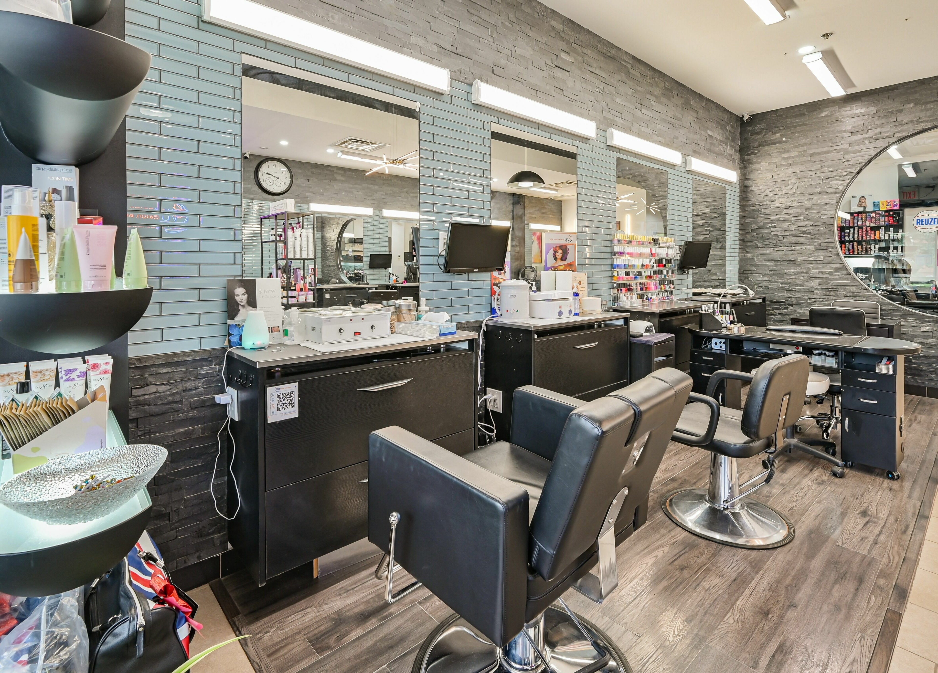 Modern salon setup at VU Salon and Spa in Mississauga, Ontario, CA, showcasing sleek chairs and beauty products.