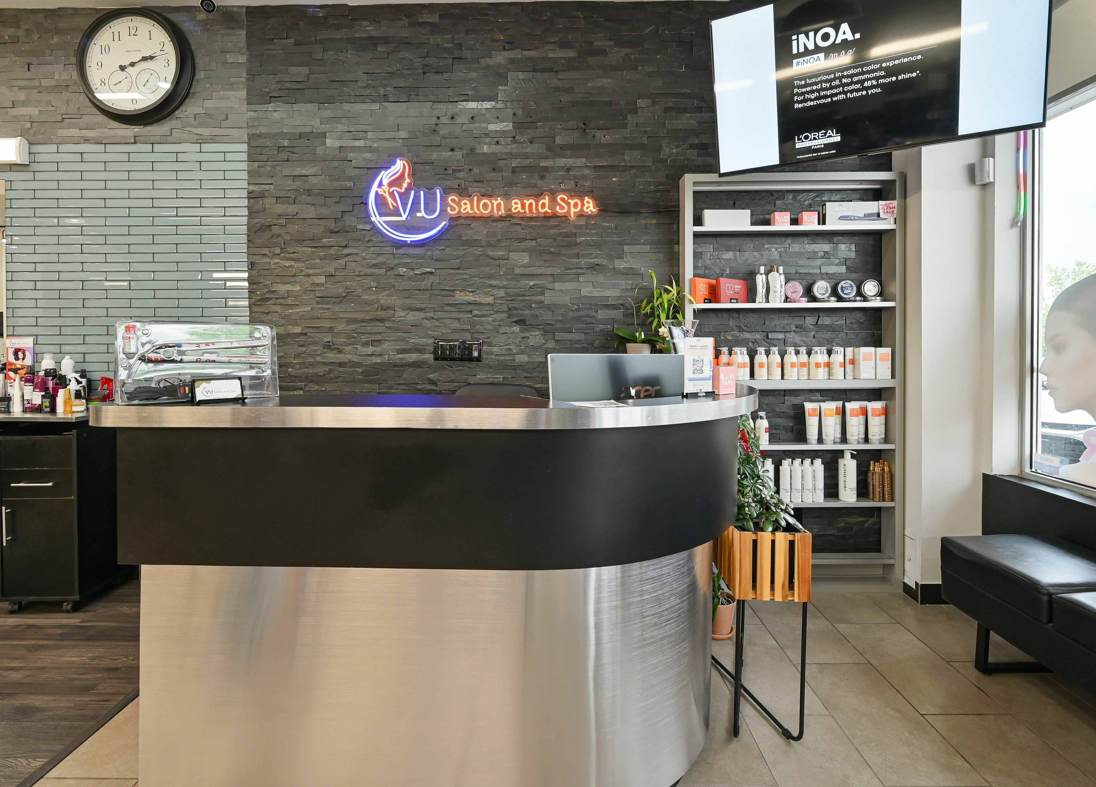 Modern reception desk at VU Salon and Spa in Mississauga, Ontario, CA showcasing sleek decor and products.