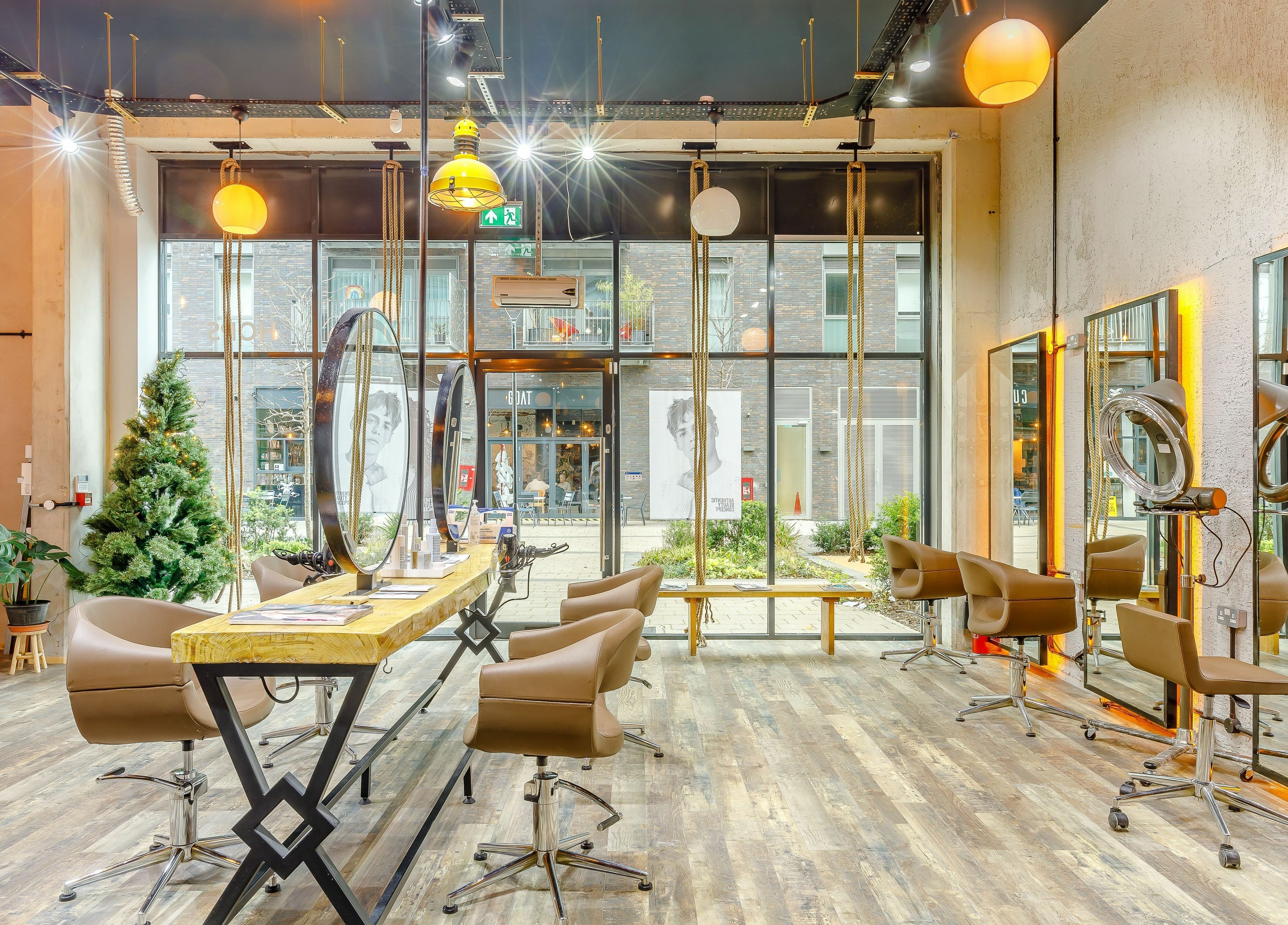 Bright, modern interior of Hops London in London, England, GB with stylish chairs and mirrors.