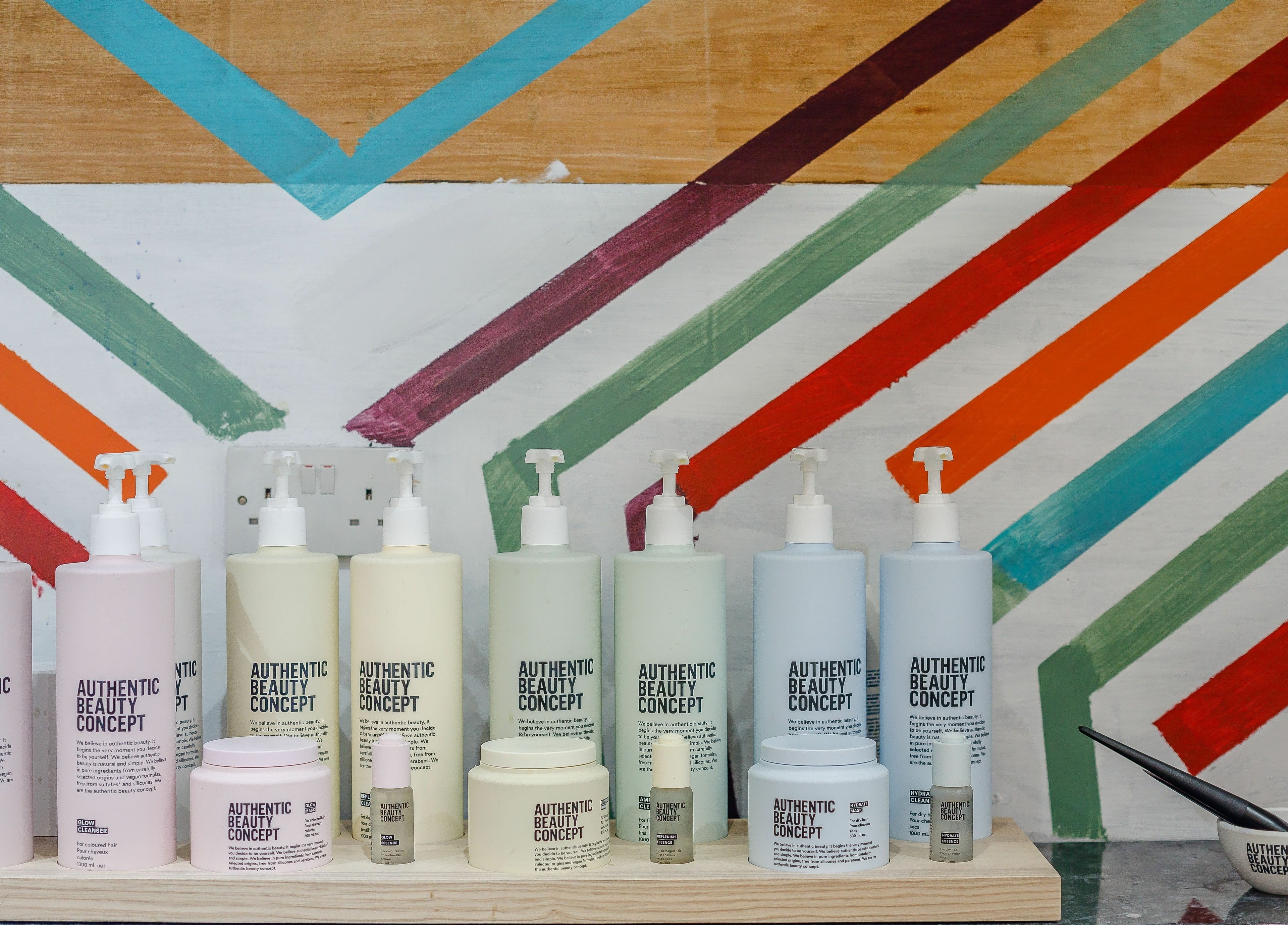 Authentic Beauty Concept products on display at Hops London, London, England, GB, with a colorful background.