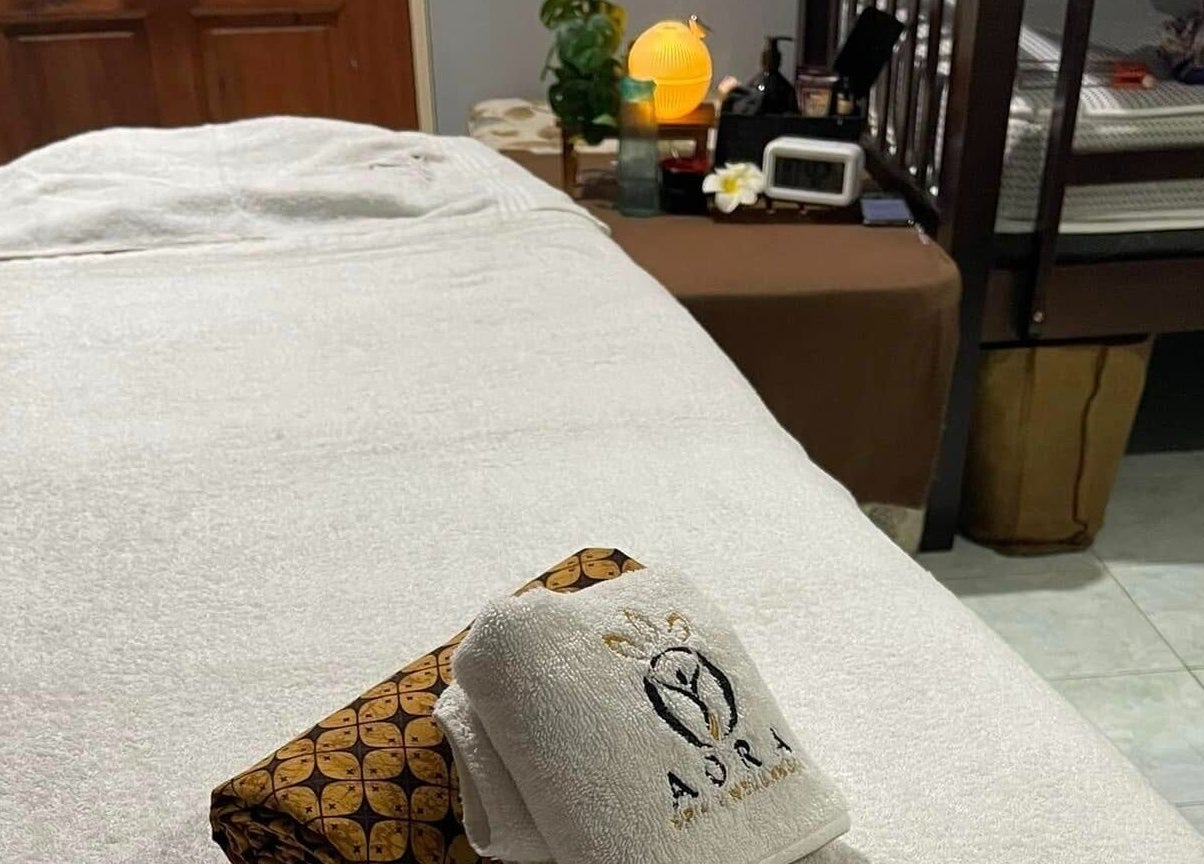 Relaxing treatment bed setup at Aora Spa and Wellness - Lumut, Lumut, Perak, MY with massage essentials.