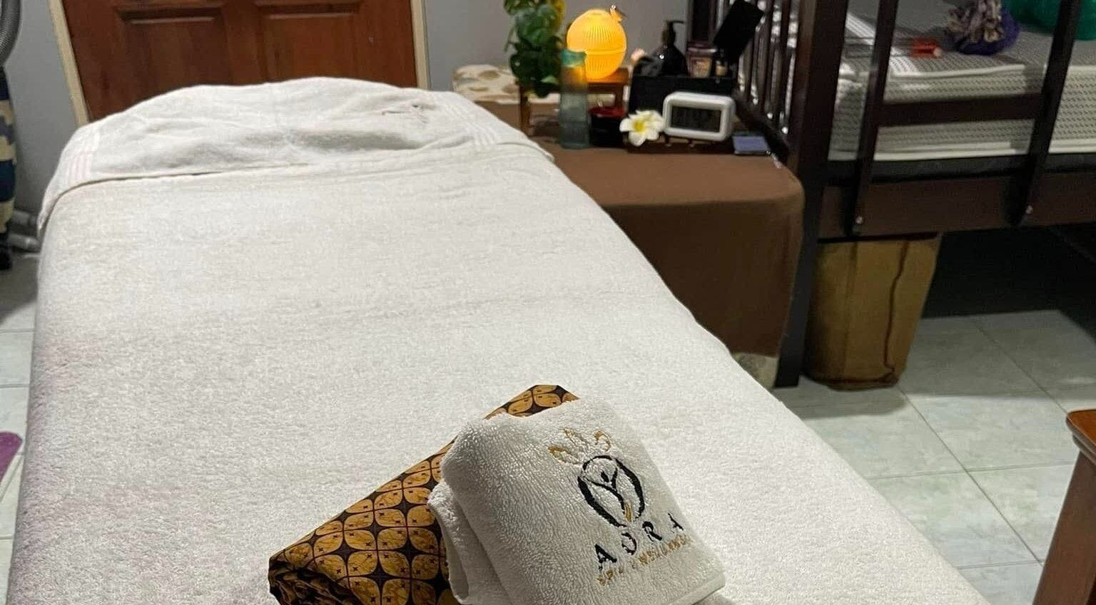 Relaxing treatment bed setup at Aora Spa and Wellness - Lumut, Lumut, Perak, MY with massage essentials.