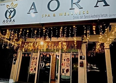 Illuminated entrance of AORA Spa and Wellness Sungai Petani, Kedah, MY, adorned with twinkling lights.