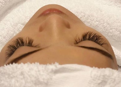 Facial treatment at AORA Spa and Wellness Sungai Petani, Kedah, MY, showcasing relaxed client with lush lashes.