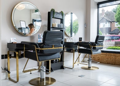 Modern salon interior with chic mirrors at Salon No. 100, Bentley Heath, England, GB.