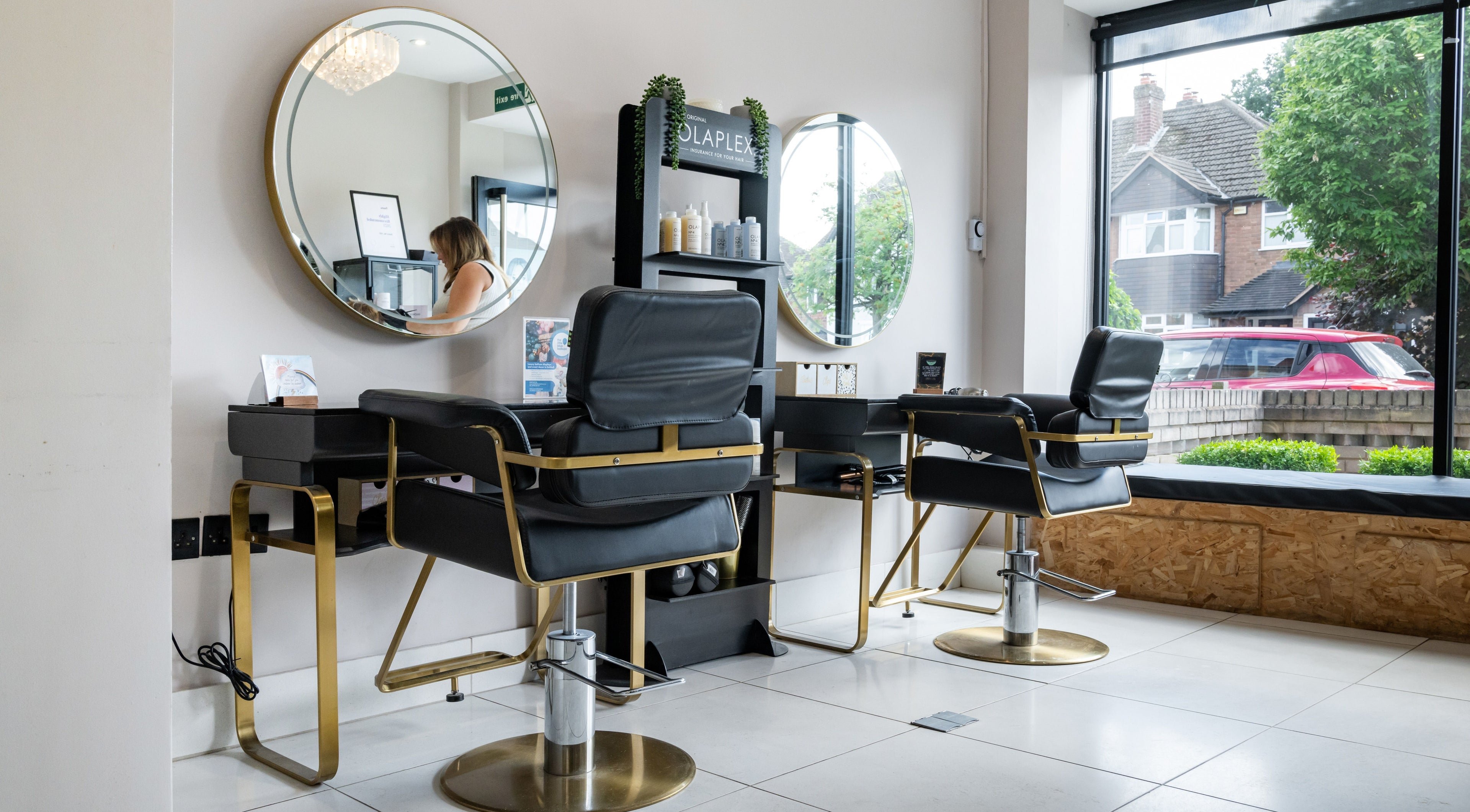 Modern salon interior with chic mirrors at Salon No. 100, Bentley Heath, England, GB.