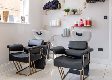 Modern salon chairs and shelves at Salon No. 100 in Bentley Heath, England, GB.