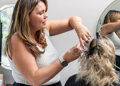 Professional hair stylist at Salon No. 100 in Bentley Heath, England GB creating a stylish haircut.