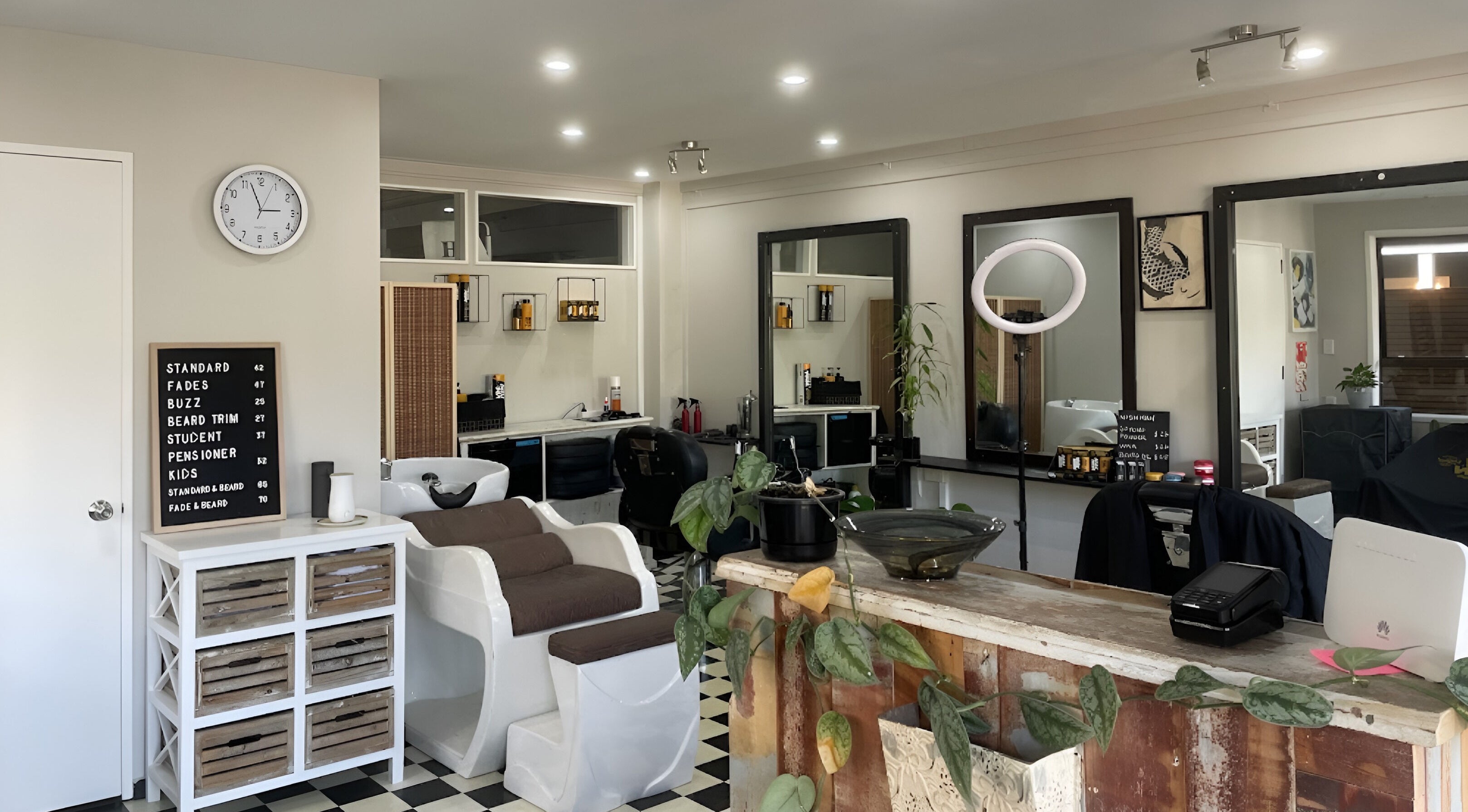 Interior of The Barbershop Waiheke, Waiheke Island, Auckland, NZ. Modern and stylish salon with sleek decor.