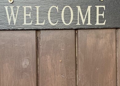 Welcome sign on wood at Holistic Therapy by Kayleigh, Baldock, England, GB. Inviting and serene entrance.
