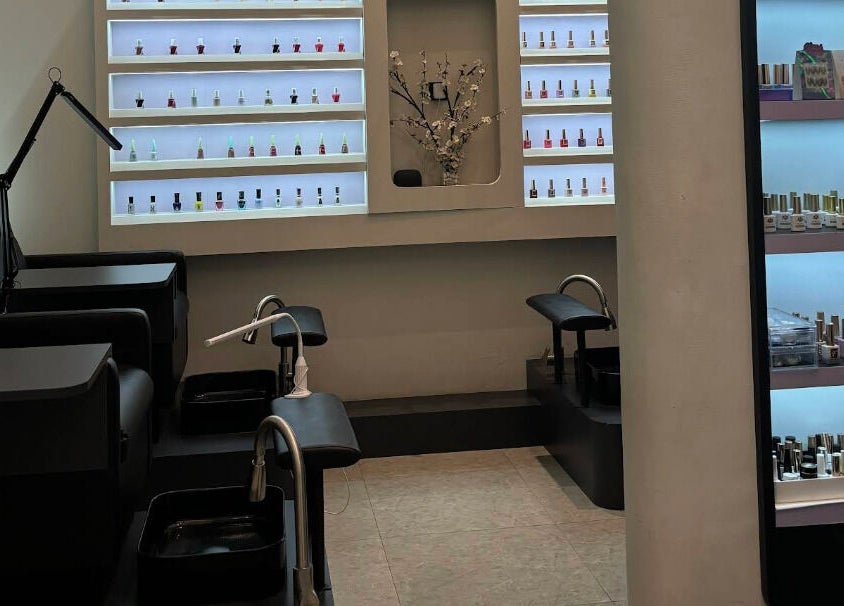 Elegant nail care area at Blanca Studio Senayan, Daerah Khusus Ibukota Jakarta. Sleek chairs and polish display.