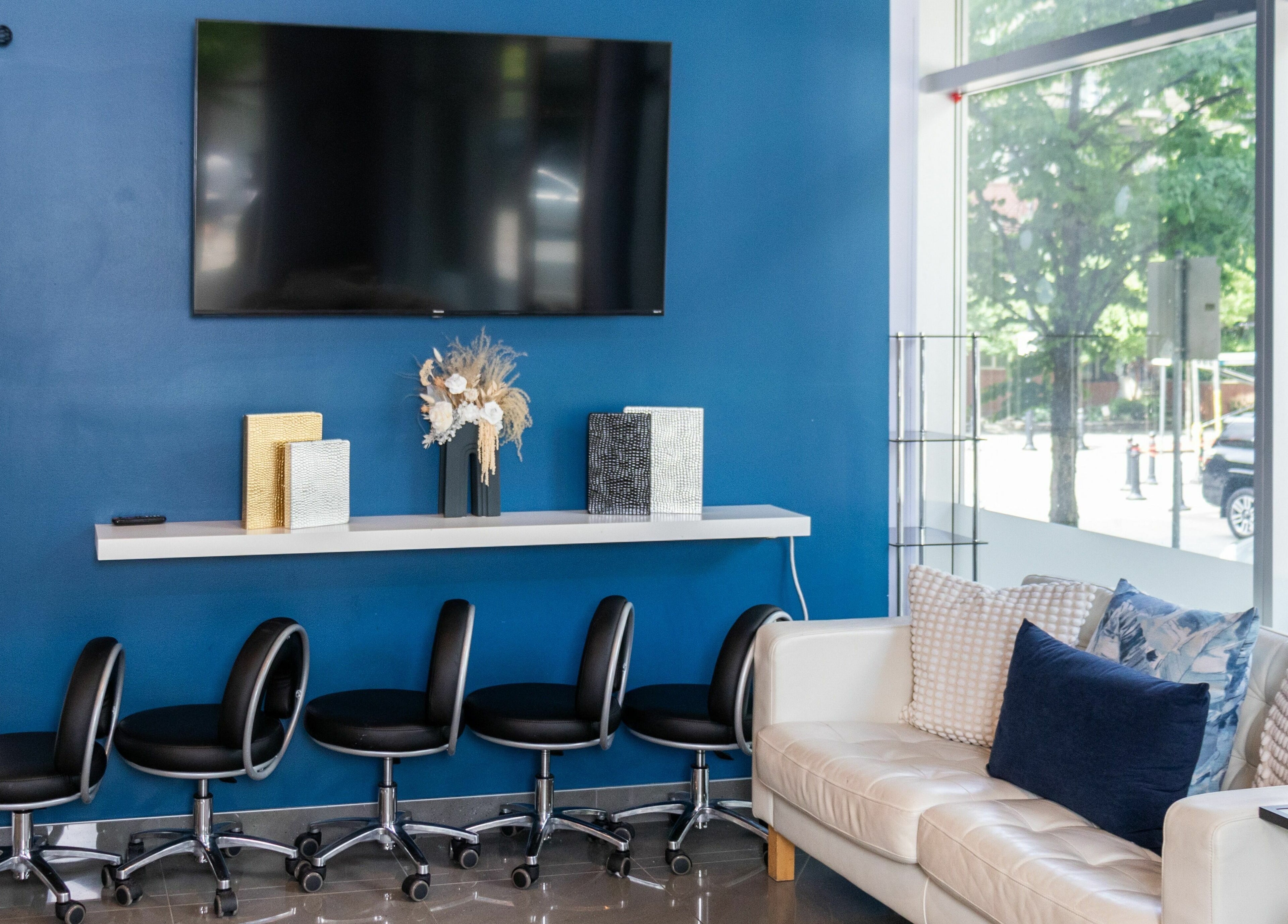 Modern seating area at The Inlet Nail Studio, Port Moody, BC, CA, with sleek chairs and decor.