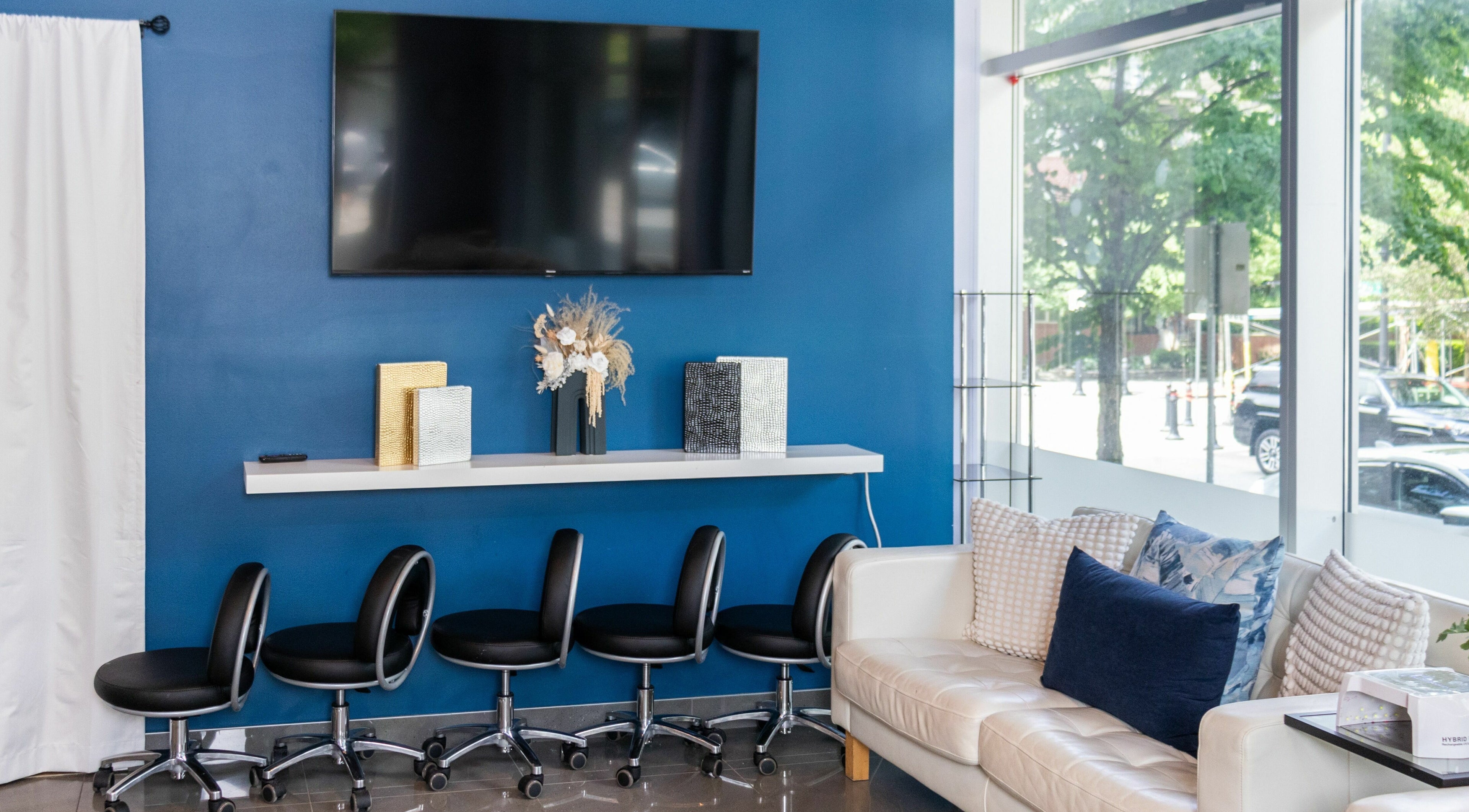 Modern seating area at The Inlet Nail Studio, Port Moody, BC, CA, with sleek chairs and decor.