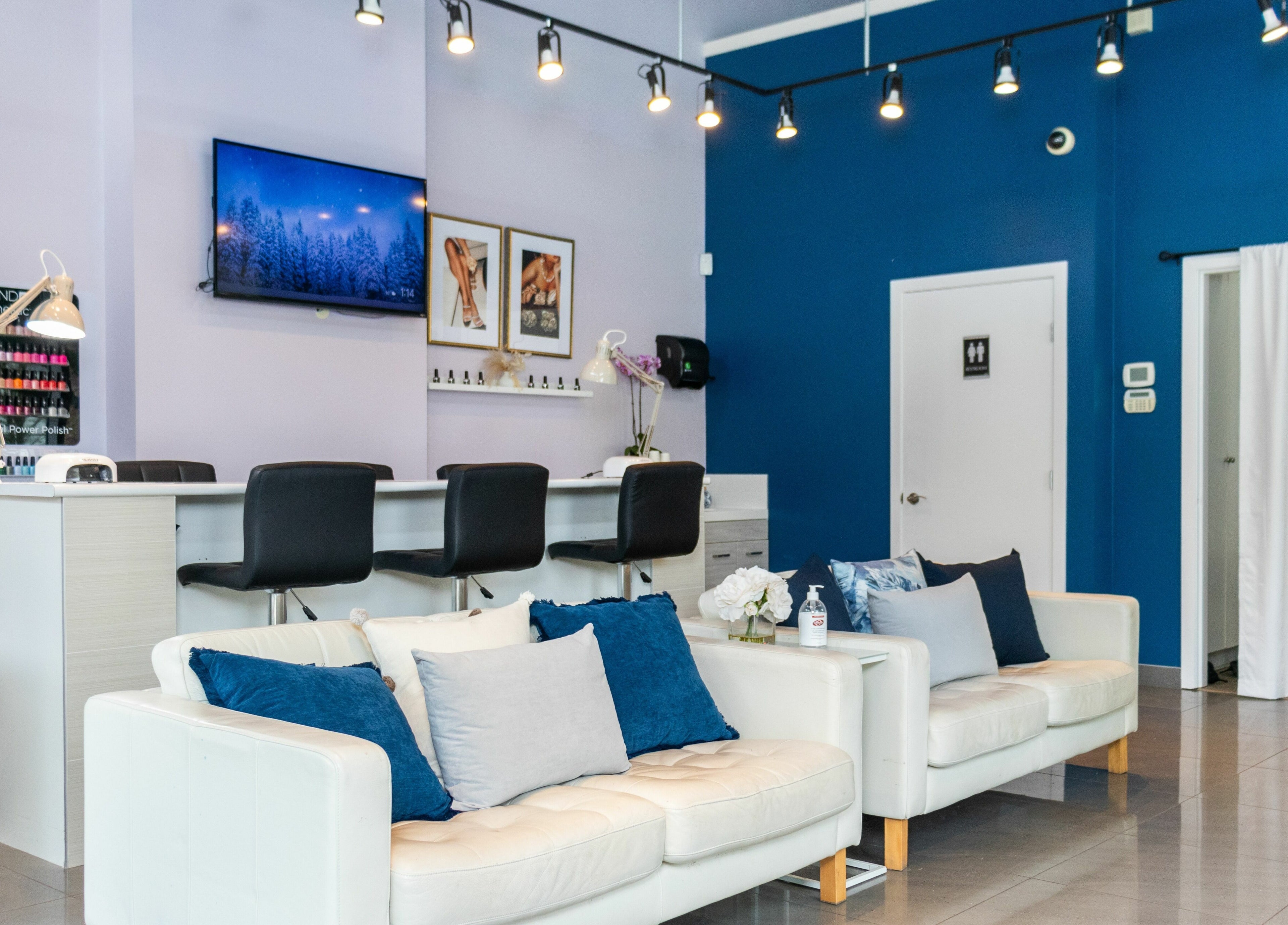 Modern interior of The Inlet Nail Studio in Port Moody, British Columbia, CA with cozy seating and nail stations.