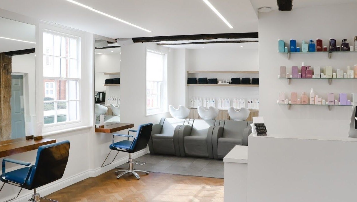 Modern salon interior at Tonics, Horsham, England, GB with sleek decor and stylish seating.