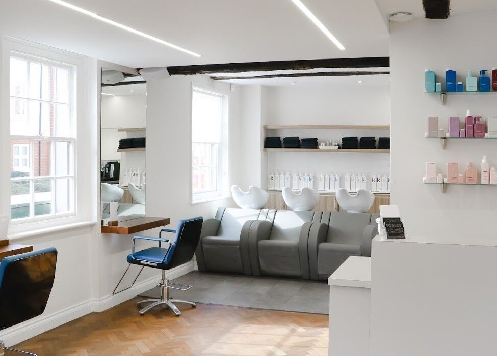 Modern salon interior at Tonics, Horsham, England, GB with sleek decor and stylish seating.