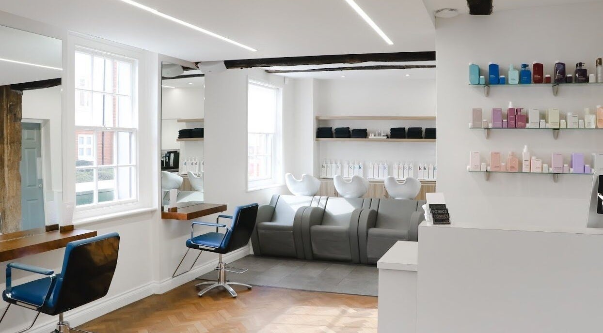 Modern salon interior at Tonics, Horsham, England, GB with sleek decor and stylish seating.