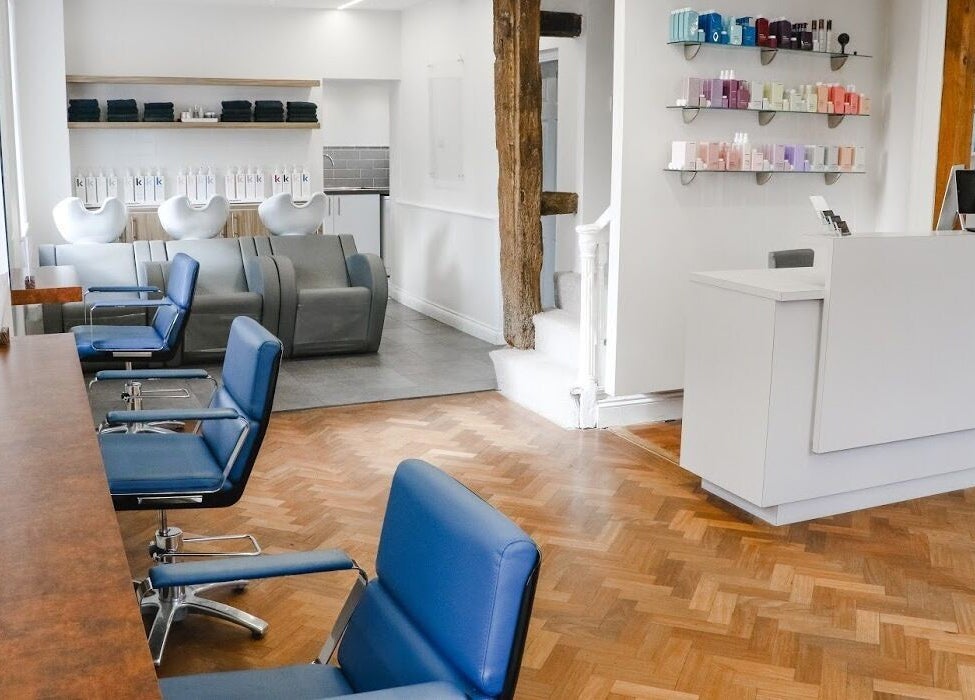 Chic beauty salon interior at Tonics, Horsham, England, GB with stylish chairs and sleek decor.