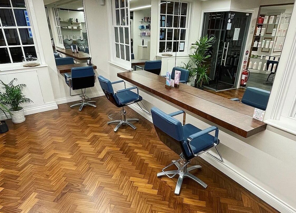 Chic salon interior at Tonics, Horsham, England, GB showcasing sleek design with modern chairs and mirrors.
