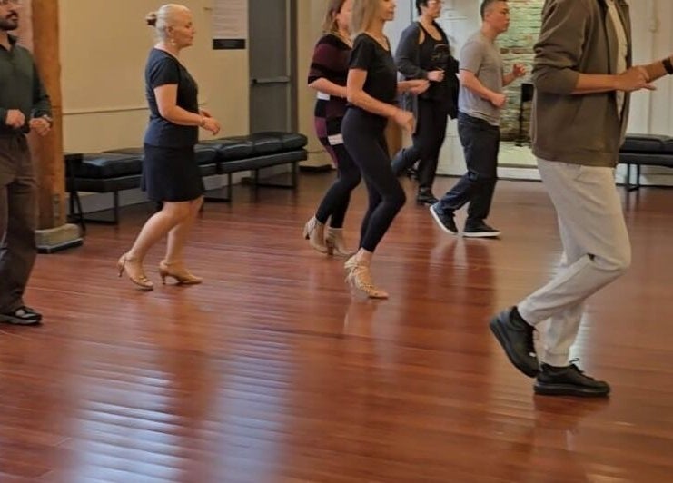 Dance class in session at PIVOT Dance Emporium, Seattle, Washington, US, featuring participants learning moves.