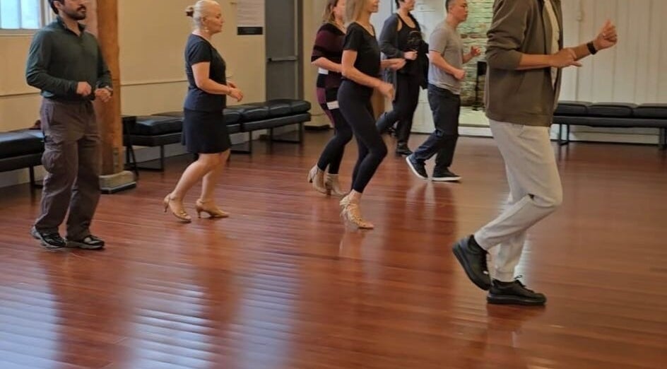 Dance class in session at PIVOT Dance Emporium, Seattle, Washington, US, featuring participants learning moves.