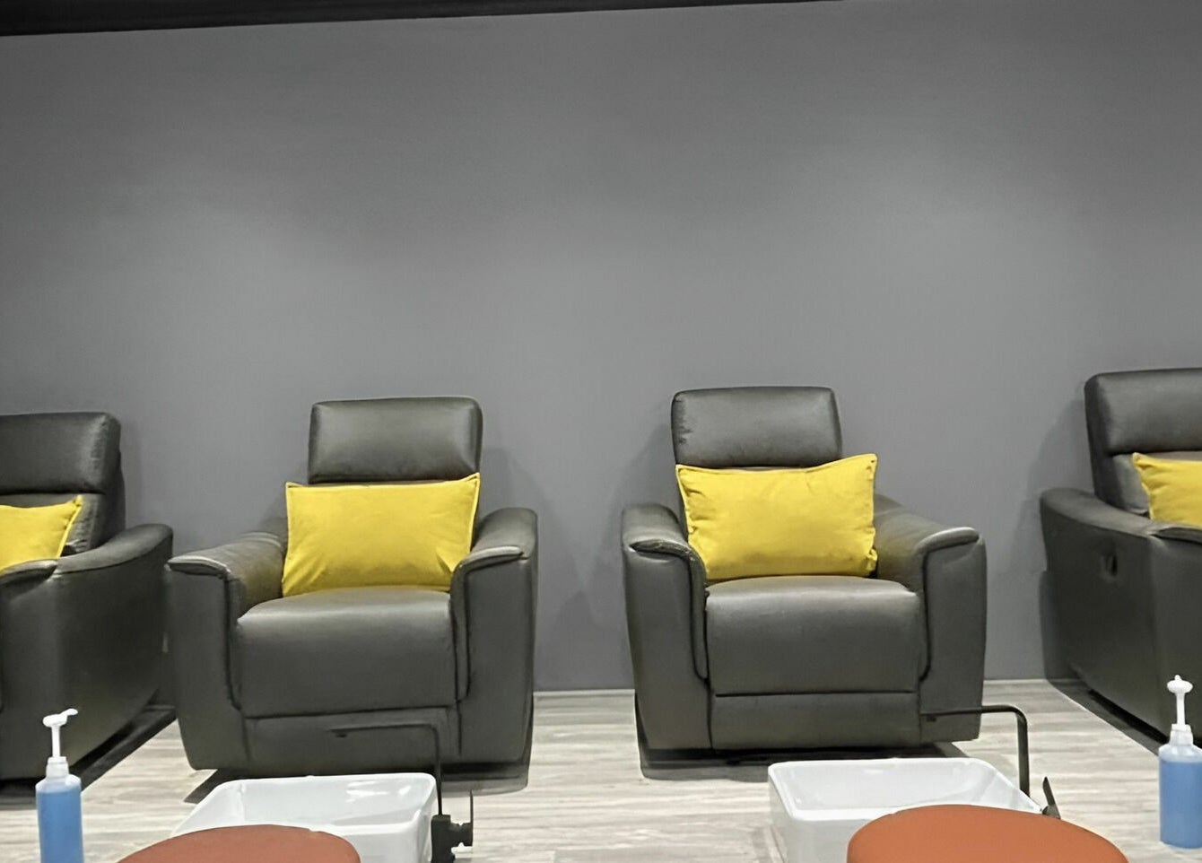Chic pedicure chairs at Giggles n Kurls Nail Studio Midrand, Midrand, Gauteng, ZA with yellow cushions.