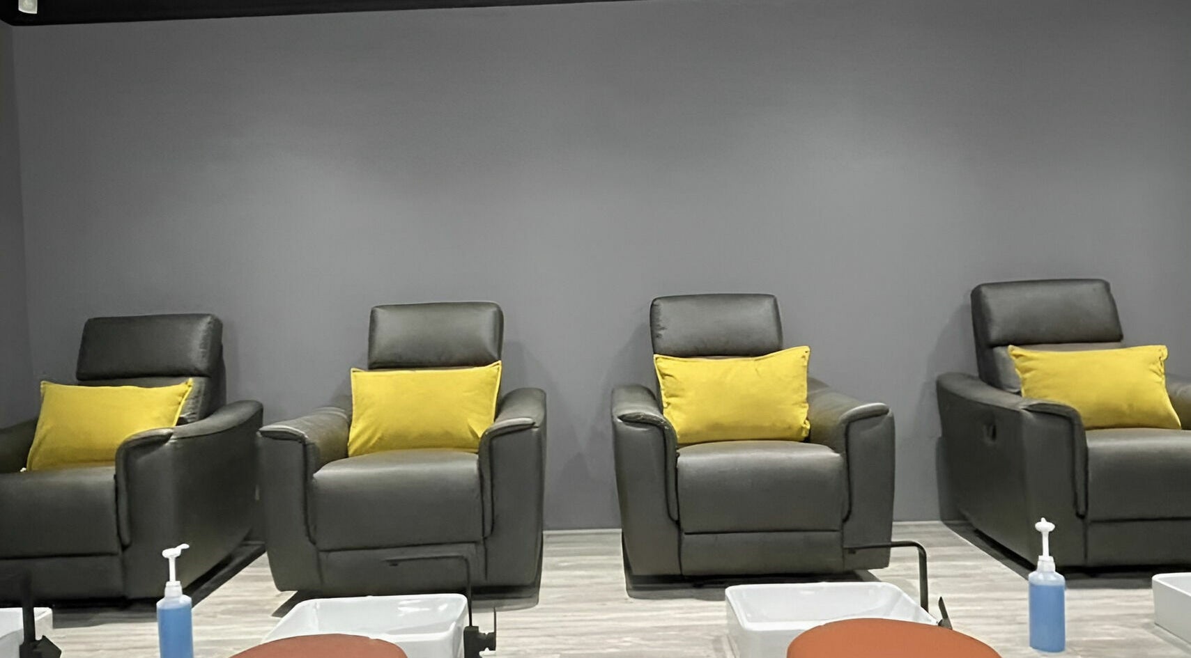 Chic pedicure chairs at Giggles n Kurls Nail Studio Midrand, Midrand, Gauteng, ZA with yellow cushions.